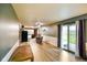 Bright living space with kitchen access, ceiling fan, and sliding door at 507 S Grant St, Brownsburg, IN 46112
