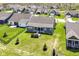 Aerial shot of the backyard featuring a lush lawn, landscaping, and an outdoor patio area at 5158 Montview Way, Noblesville, IN 46062
