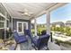 Covered back porch with seating area, ceiling fan, and views of the backyard at 5158 Montview Way, Noblesville, IN 46062