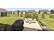 Outdoor patio with table, chairs, and grill overlooking the well manicured yard and neighborhood at 5158 Montview Way, Noblesville, IN 46062
