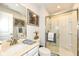 Bright bathroom features a glass-enclosed shower and a vanity with a modern sink at 5158 Montview Way, Noblesville, IN 46062
