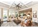 Spacious living room with coffered ceilings, hardwood floors, an ottoman and open access to the kitchen at 5158 Montview Way, Noblesville, IN 46062