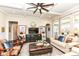 Elegant living room with coffered ceilings, a ceiling fan, hardwood floors, and stylish furniture at 5158 Montview Way, Noblesville, IN 46062