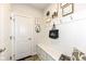 Mudroom boasts white wainscoting, coat hooks, a storage bench, and stylish decor at 5158 Montview Way, Noblesville, IN 46062