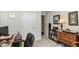 This office features neutral walls, carpet, a wood desk, and a bookshelf with books and decorations at 5158 Montview Way, Noblesville, IN 46062