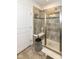 Modern bathroom featuring a tiled shower with a glass door and decorative stool at 5158 Montview Way, Noblesville, IN 46062
