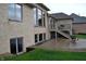 Backyard featuring a brick exterior, a deck with stairs, a patio, and a well-manicured lawn at 5361 Ashby Ct, Greenwood, IN 46143