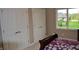 Bedroom featuring a double door closet, window and bed with purple floral pattern at 5361 Ashby Ct, Greenwood, IN 46143