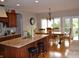Open kitchen with dining area, featuring granite countertops, stainless appliances, and hardwood floors at 5361 Ashby Ct, Greenwood, IN 46143