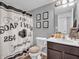 Bathroom with decorative shower curtain, framed prints and dark wood vanity at 546 Freedom Dr, Pittsboro, IN 46167
