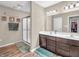 Bathroom showcasing a double vanity, framed mirrors, walk-in shower and a walk in closet at 546 Freedom Dr, Pittsboro, IN 46167