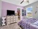 This bedroom features a dresser with TV, and an organized closet at 546 Freedom Dr, Pittsboro, IN 46167