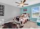Cozy bedroom with unique bedding, a ceiling fan, and a bright window with plenty of natural light at 546 Freedom Dr, Pittsboro, IN 46167