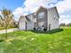 Well-maintained two-story home with a landscaped front yard and pond at 546 Freedom Dr, Pittsboro, IN 46167