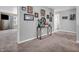Hallway features neutral walls, plush carpeting, and a decorative table with unique accents at 546 Freedom Dr, Pittsboro, IN 46167