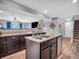Spacious kitchen features a center island, granite countertops, and hardwood flooring at 546 Freedom Dr, Pittsboro, IN 46167