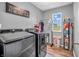 Efficient laundry room with modern machines, storage shelves, and a bright window at 546 Freedom Dr, Pittsboro, IN 46167
