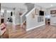 Spacious living room with hardwood floors, staircase, and plenty of natural light at 546 Freedom Dr, Pittsboro, IN 46167