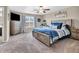 Spacious primary bedroom with a ceiling fan, large windows, and stylish, neutral decor at 546 Freedom Dr, Pittsboro, IN 46167