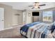 Bright primary bedroom with a ceiling fan, large windows, and stylish, neutral decor at 546 Freedom Dr, Pittsboro, IN 46167