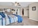 Bright primary bedroom with stylish decor, a ceiling fan, and a view into the closet at 546 Freedom Dr, Pittsboro, IN 46167