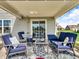This covered patio features stylish outdoor furniture and decor at 546 Freedom Dr, Pittsboro, IN 46167