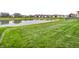 Scenic view of the pond in the backyard surrounded by greenery and grass at 546 Freedom Dr, Pittsboro, IN 46167