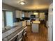 Eat-in kitchen equipped with appliances, center island, wood floor, and ample counter space at 5640 Dapple Ct, Indianapolis, IN 46228