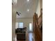 Comfortable living room with wood floors and staircase, featuring a ceiling fan and natural light at 5640 Dapple Ct, Indianapolis, IN 46228