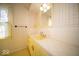 A functional bathroom with yellow tiled floor and retro vanity, perfect for a quick refresh at 5829 Lasalle St, Indianapolis, IN 46220