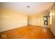 A simple, bright bedroom featuring hardwood floors, closet space, and an ensuite bathroom at 5829 Lasalle St, Indianapolis, IN 46220