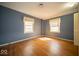 A bright bedroom with hardwood floors, offering a comfortable and inviting space with plenty of natural light at 5829 Lasalle St, Indianapolis, IN 46220