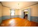 Bright dining room with hardwood floors and a view of the kitchen area, perfect for entertaining at 5829 Lasalle St, Indianapolis, IN 46220