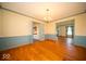 Open dining room features hardwood floors, stylish lighting, and access to a kitchen and other rooms at 5829 Lasalle St, Indianapolis, IN 46220