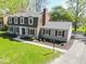 Well-maintained two-story home with gray siding, brick chimney, and landscaped yard at 5829 Lasalle St, Indianapolis, IN 46220