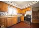 This kitchen features wood cabinets, stainless steel appliances and floral wallpaper at 5829 Lasalle St, Indianapolis, IN 46220