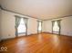 Bright living room featuring hardwood floors, neutral walls and many windows at 5829 Lasalle St, Indianapolis, IN 46220