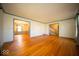 Open living room with hardwood floors, neutral paint, and trim, and views to the dining room at 5829 Lasalle St, Indianapolis, IN 46220