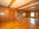 Spacious living room features wood paneling, a brick fireplace, and hardwood floors at 5829 Lasalle St, Indianapolis, IN 46220