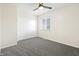 Bedroom with gray carpet, a ceiling fan, a window, and a closet with sliding doors at 6026 Oakbrook Ln, Indianapolis, IN 46254