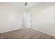 Bright bedroom features neutral walls, carpet, a ceiling fan, and an open doorway at 6026 Oakbrook Ln, Indianapolis, IN 46254