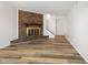 Bright living room features beautiful floors and a cozy brick fireplace, creating a welcoming atmosphere at 6026 Oakbrook Ln, Indianapolis, IN 46254