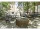 Outdoor space with fire pit, benches, and mature trees, perfect for relaxing or socializing at 624 E Walnut St # 46, Indianapolis, IN 46204