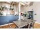 Open-concept dining area with modern table, chairs, and lighting, seamlessly connecting to the kitchen at 624 E Walnut St # 46, Indianapolis, IN 46204
