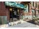 Building entrance with awning and brick facade, modern glass doors, and black iron fence detail at 624 E Walnut St # 46, Indianapolis, IN 46204