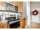 Modern kitchen features stainless steel appliances, granite countertops, and wood cabinetry at 624 E Walnut St # 46, Indianapolis, IN 46204