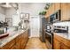 Well-lit kitchen with stainless steel appliances, granite countertops, and wooden cabinetry at 624 E Walnut St # 46, Indianapolis, IN 46204