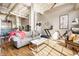 Open-concept living room with hardwood floors, fitness equipment, and stylish contemporary furnishings at 624 E Walnut St # 46, Indianapolis, IN 46204