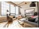 Bright living room featuring large windows, hardwood floors, and comfortable modern furniture at 624 E Walnut St # 46, Indianapolis, IN 46204