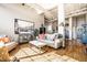 Open-concept living room with hardwood floors, fitness equipment, and stylish contemporary furnishings at 624 E Walnut St # 46, Indianapolis, IN 46204